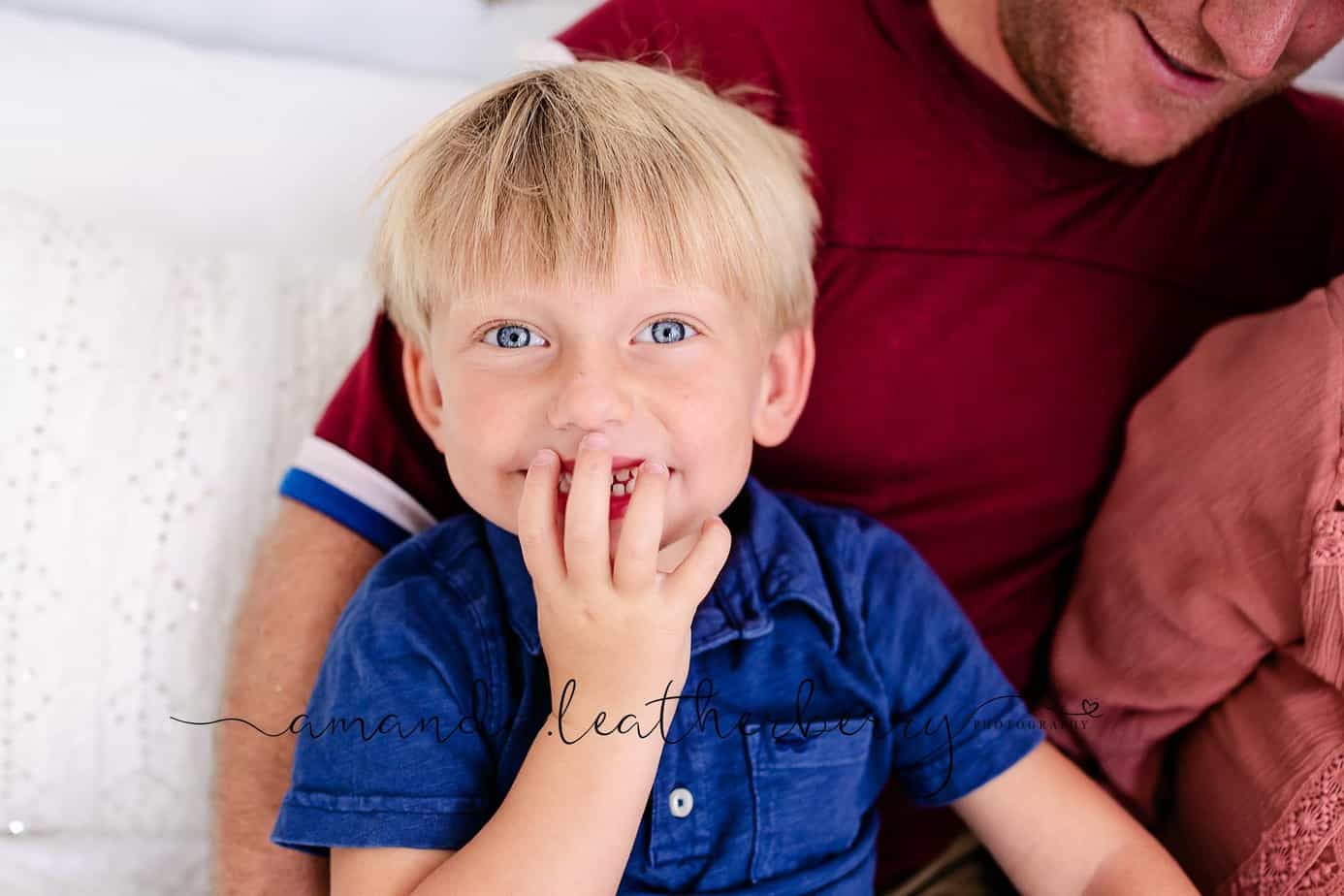 Dad and son together during newborn family session in pensacola fl studio