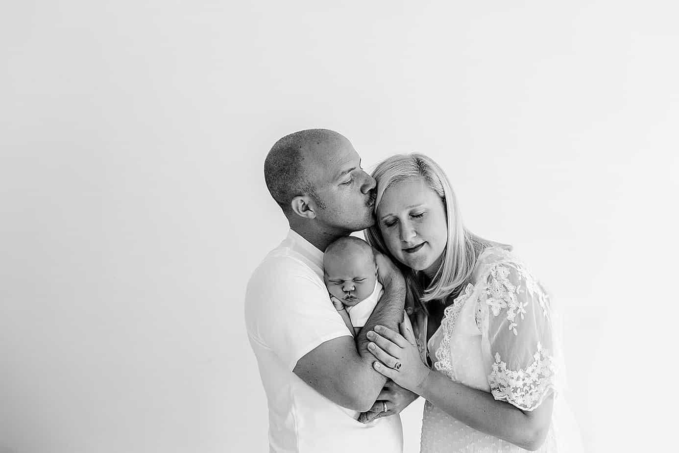 mom and dad holding newborn pensacola photography