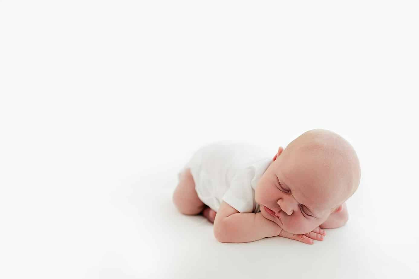 Newborn baby girl on white backdrop at pensacola photography session