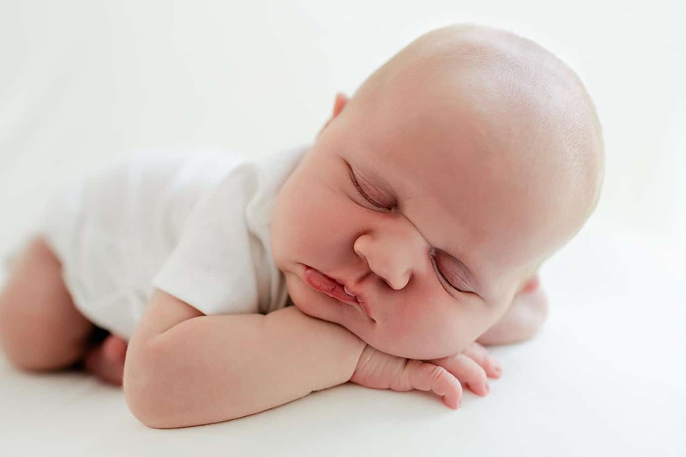 Newborn baby girl on white pensacola photography