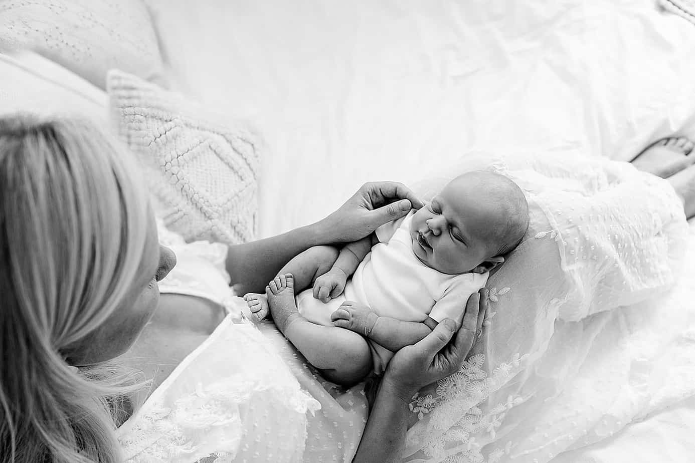 mom and newborn on bed pensacola photography