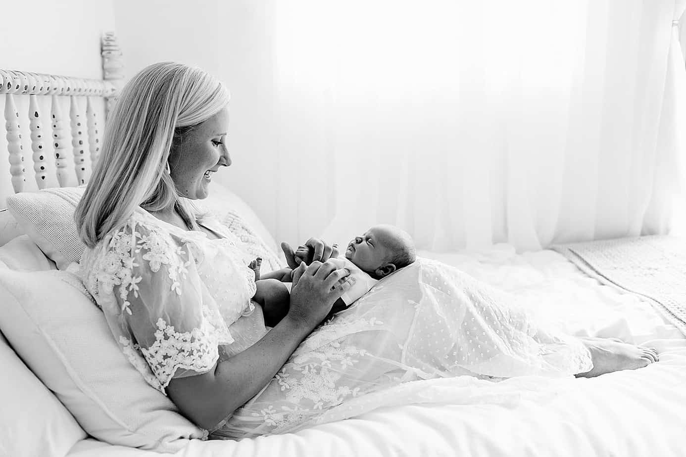 Mom and newborn on bed newborn pensacola photography