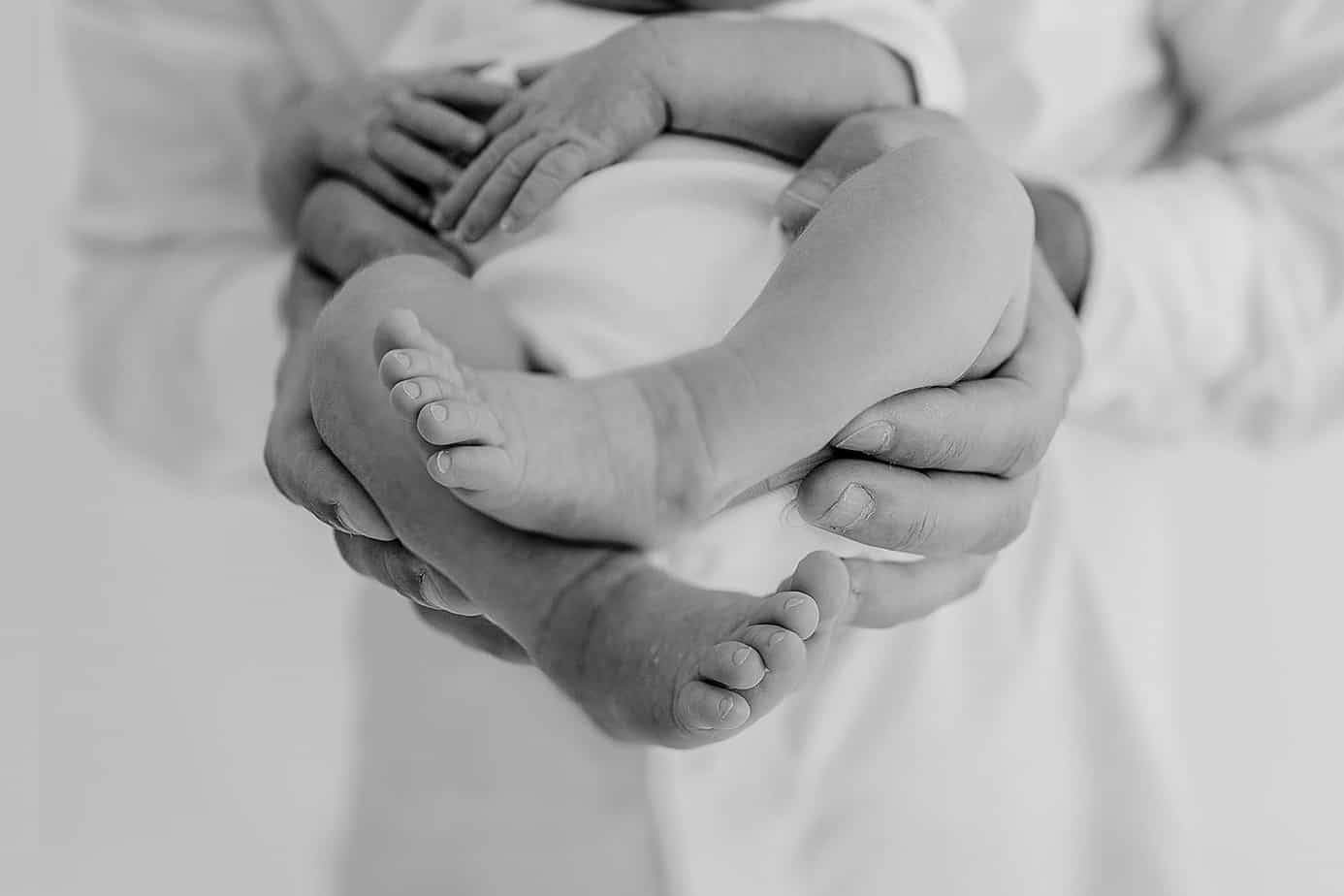 Newborn feet inside of dad's hands pensacola photographer