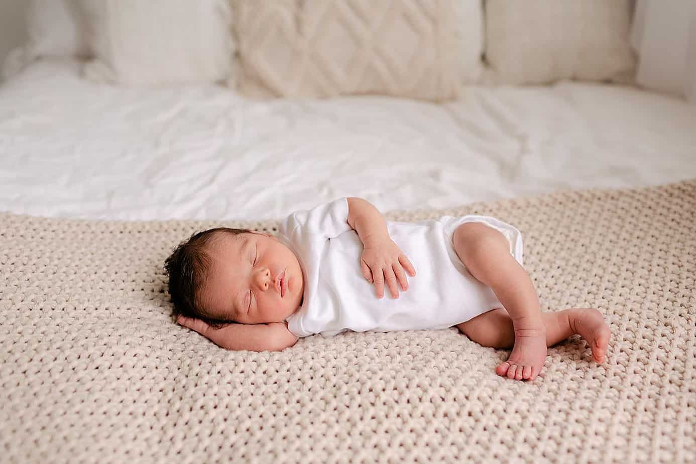 Newborn laying on bed pensacola photos 